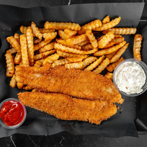 Two breaded fish fillets with crinkle-cut fries, ketchup, and tartar sauce on a black tray.