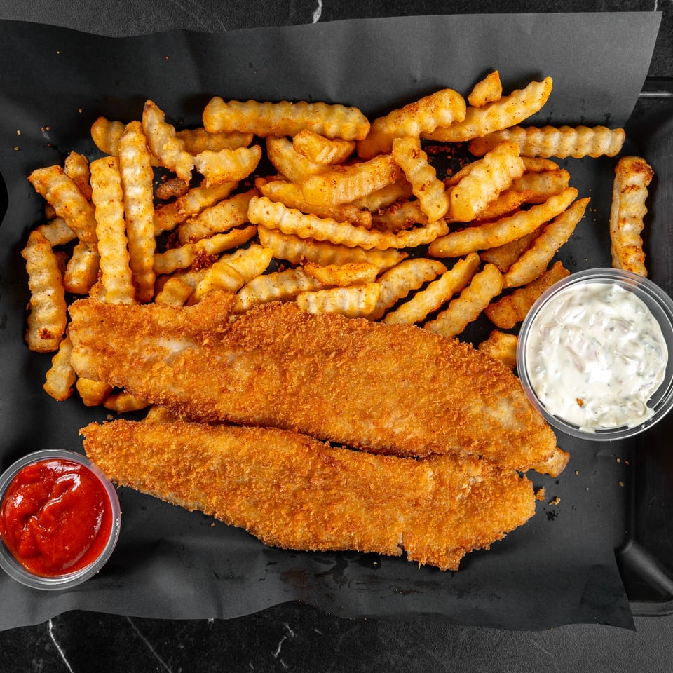 Two breaded fish fillets with crinkle-cut fries, ketchup, and tartar sauce on a black tray.